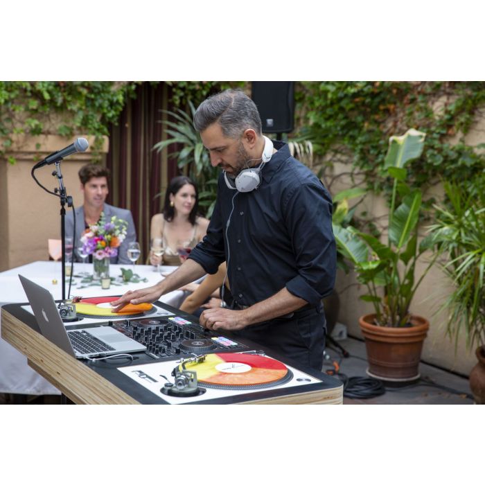 DJ using turntables, laptop and DJ Controller