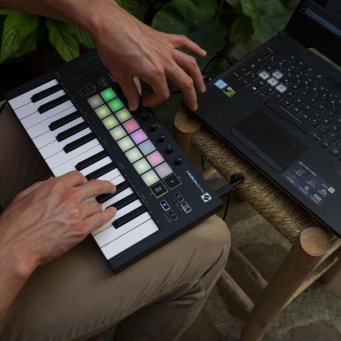 Man playing mini keyboard on lap