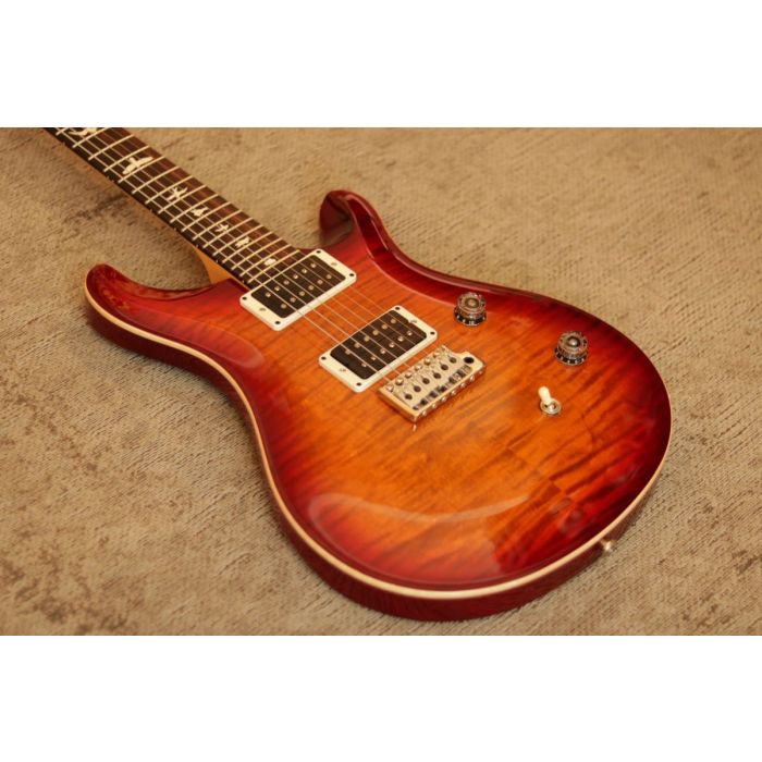 Closeup angled view of the body on a PRS CE24 Dark Cherry Sunburst Flame Electric Guitar