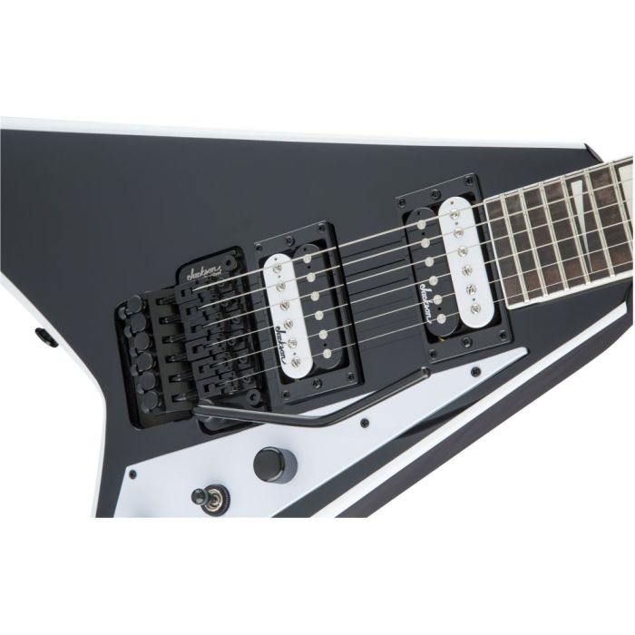 Closeup view of the pickups on a Black and White Jackson JS-series Randy Rhoads guitar